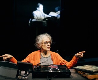 Kate Valk and, on screen, Spalding Gray (Spencer Ostrander)