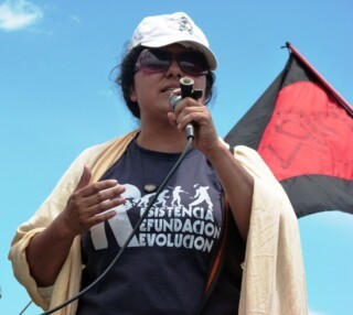 Berta Cáceres speaking outside the Soto Cano US Air Base in Honduras in 2011 (Roger Harris)