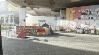 Bookshelves under the Westway next to Grenfell Tower.