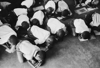 ‘Students kneel on floor to write’ (c.1965)