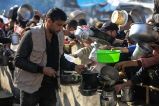 Palestinians receiving food at a donation point in Rafah, 19 December 2023. Photo © Mohammed Talatene/dpa/Alamy Live News