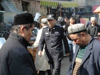 A Uighur policeman on a backstreet in Urumqi