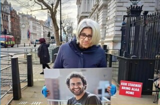 Laila Soueif with a photograph of her son, Alaa Abd el-Fattah, outside Downing Street in February 2025