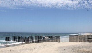 A section of the US-Mexico border painted pale blue by Ana Teresa Fernández.