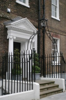 Georgian doorway with pediment and ironwork, London