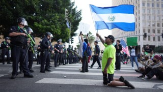 Protesters in front of police in downtown Los Angeles, 9 June 2025. (AP/Eric Thayer/Alamy)