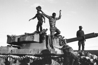 Angolan soldiers with captured South African tank, Cuito Cuanavale, 1988, photographed by Jeremy Harding.