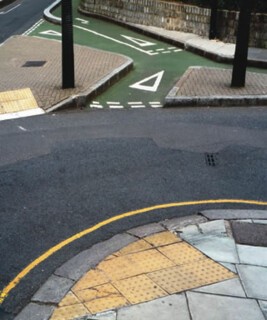 Cycle lane divided from motor traffic by kerbed barrier